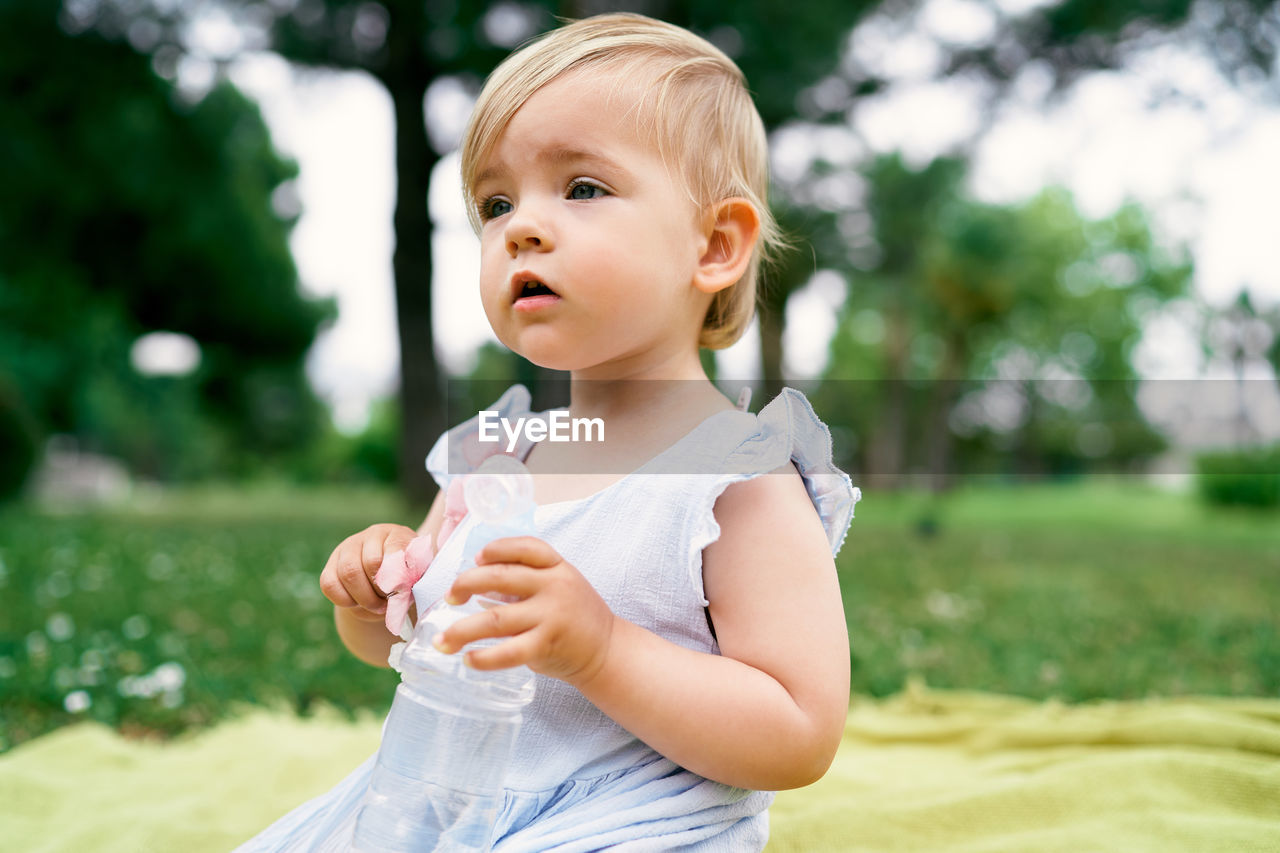 Cute girl holding bottle