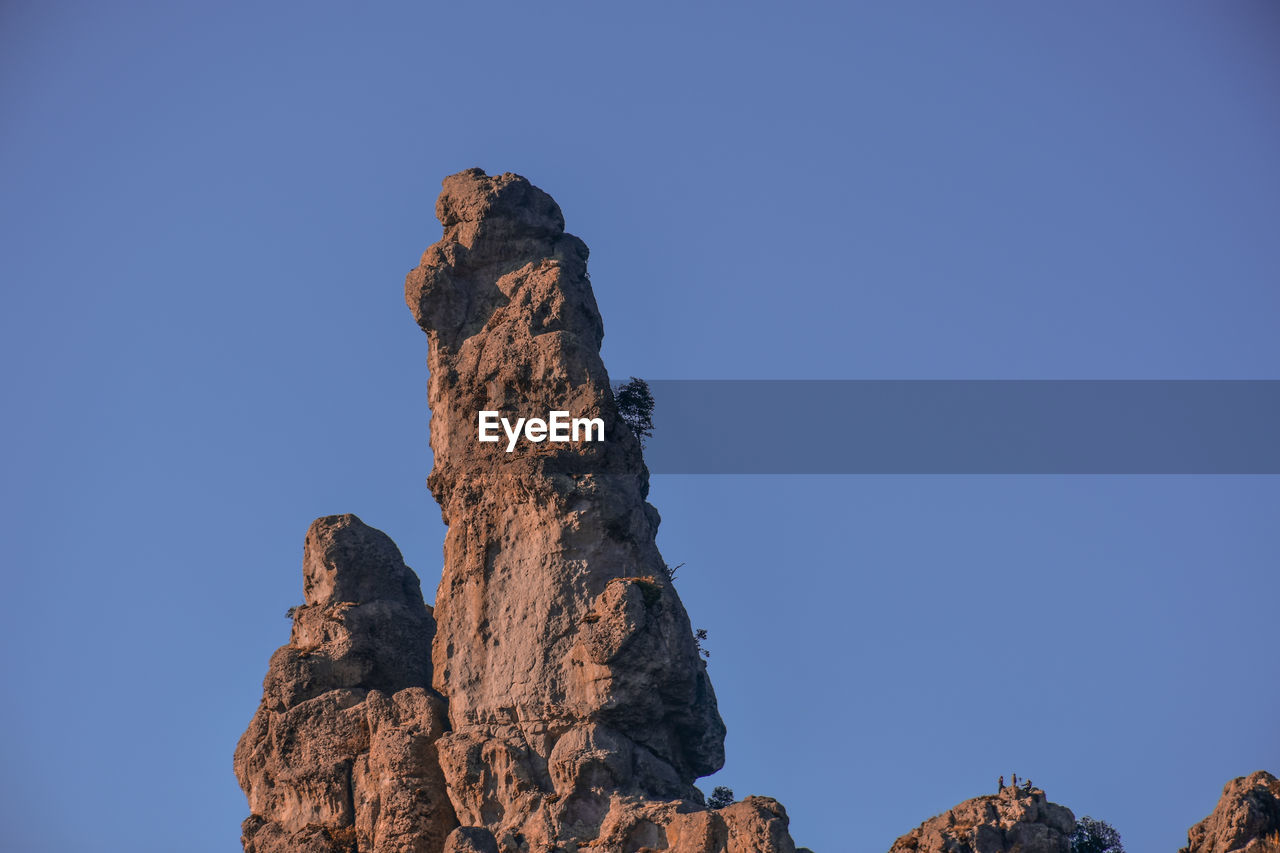 LOW ANGLE VIEW OF ROCK FORMATION AGAINST SKY