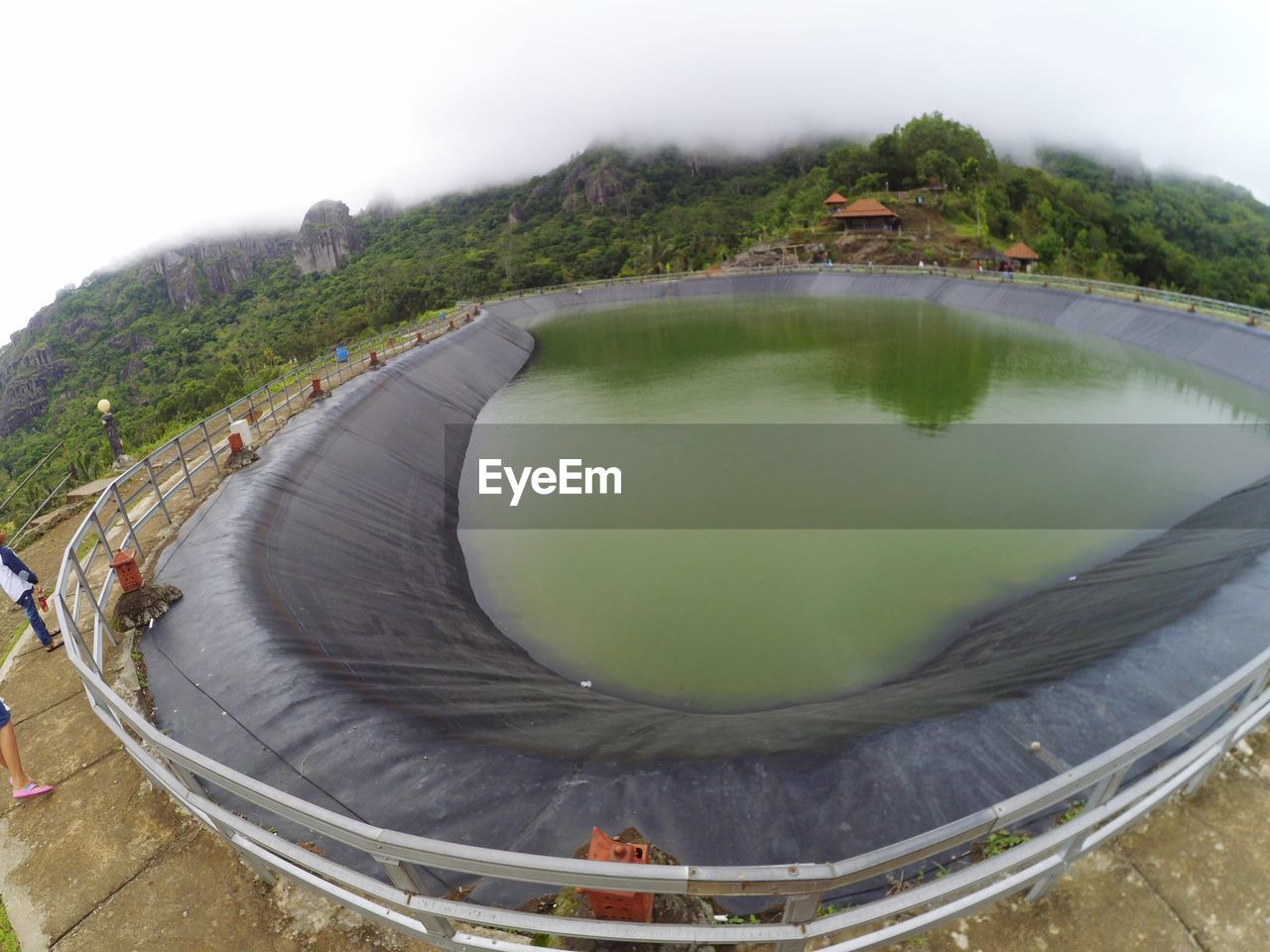 HIGH ANGLE VIEW OF LAKE AMIDST TREES AGAINST SKY