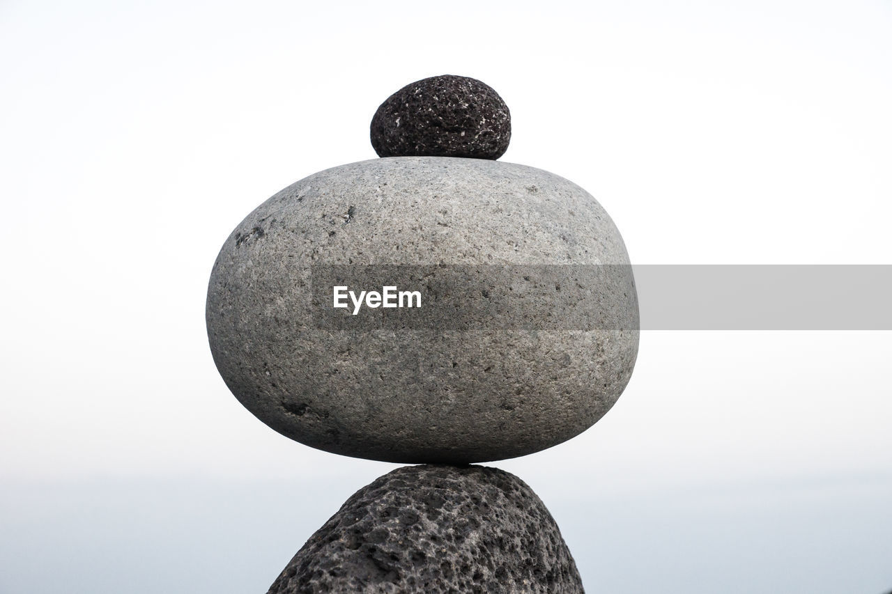 Low angle view of stone against white background