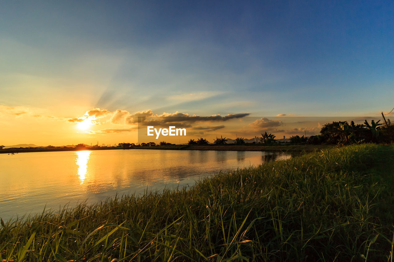 Scenic view of lake against sky during sunset