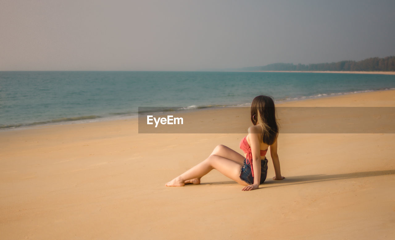 A girl sitting on the beach