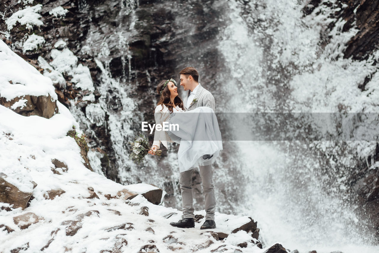 PANORAMIC VIEW OF YOUNG WOMAN STANDING IN WATER