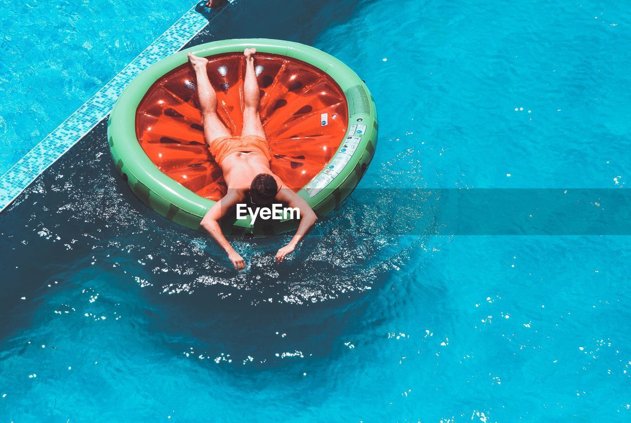 High angle view of man on ring in swimming pool