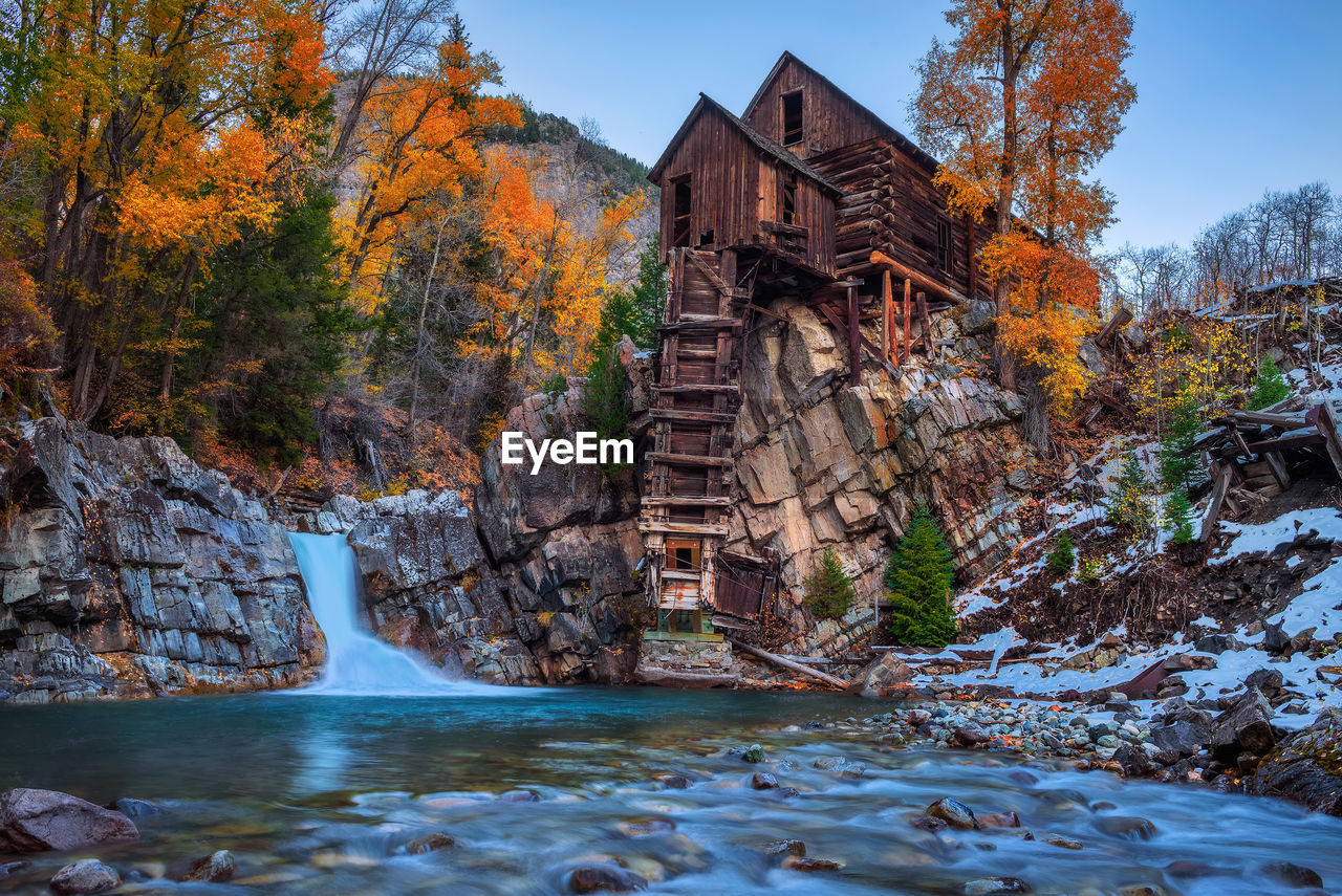 RIVER AMIDST TREES DURING AUTUMN