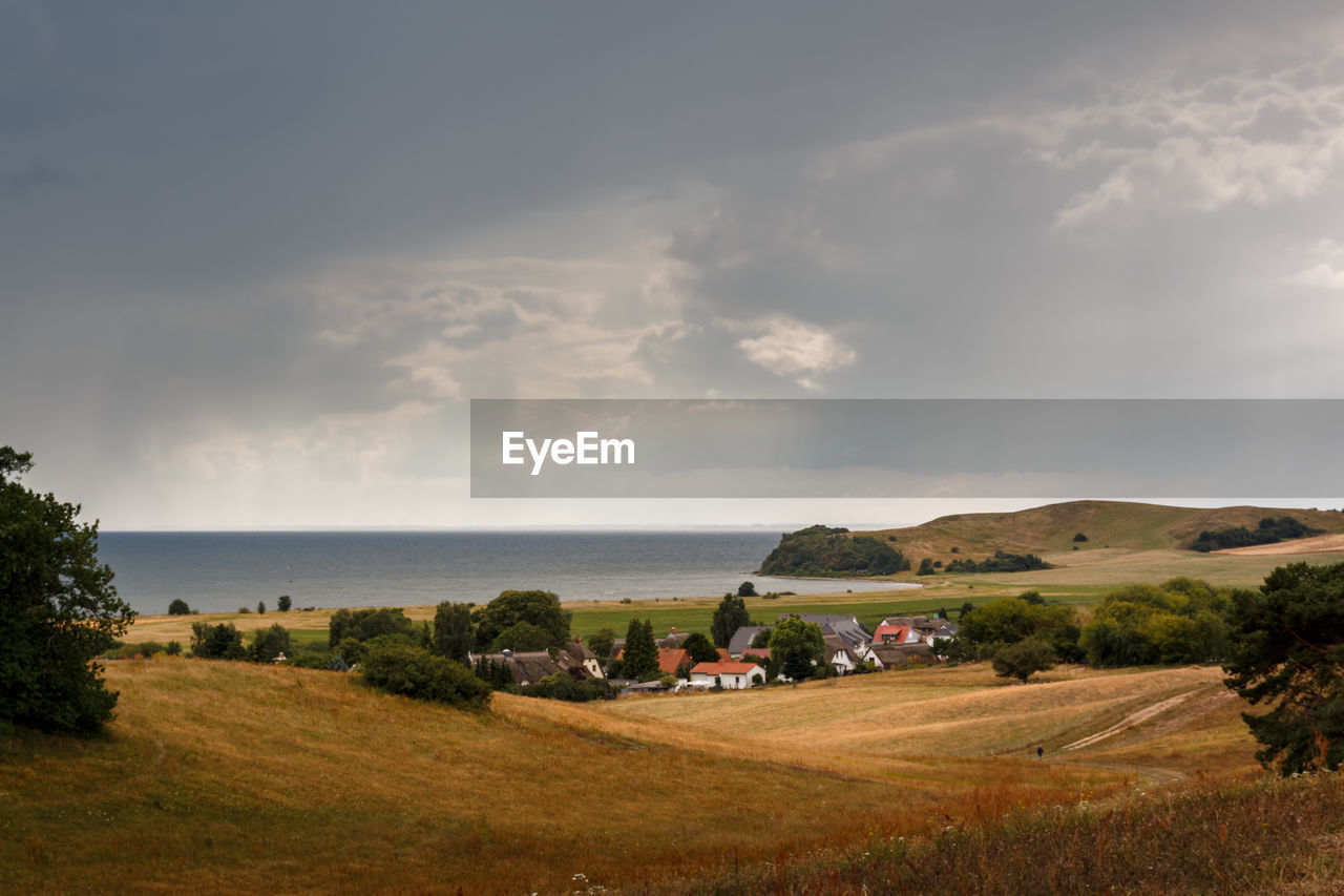 SCENIC VIEW OF SEA AND TREES AGAINST SKY