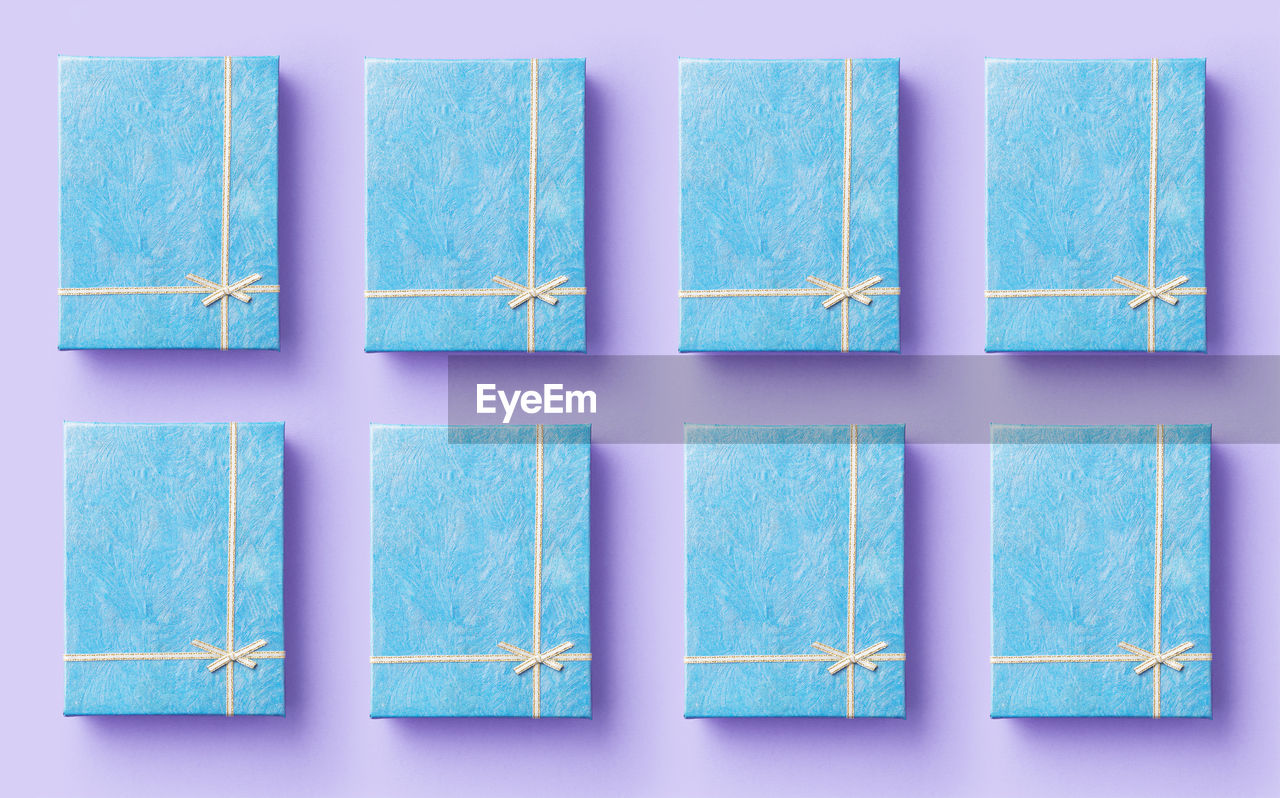 Directly above shot of gift boxes on purple background