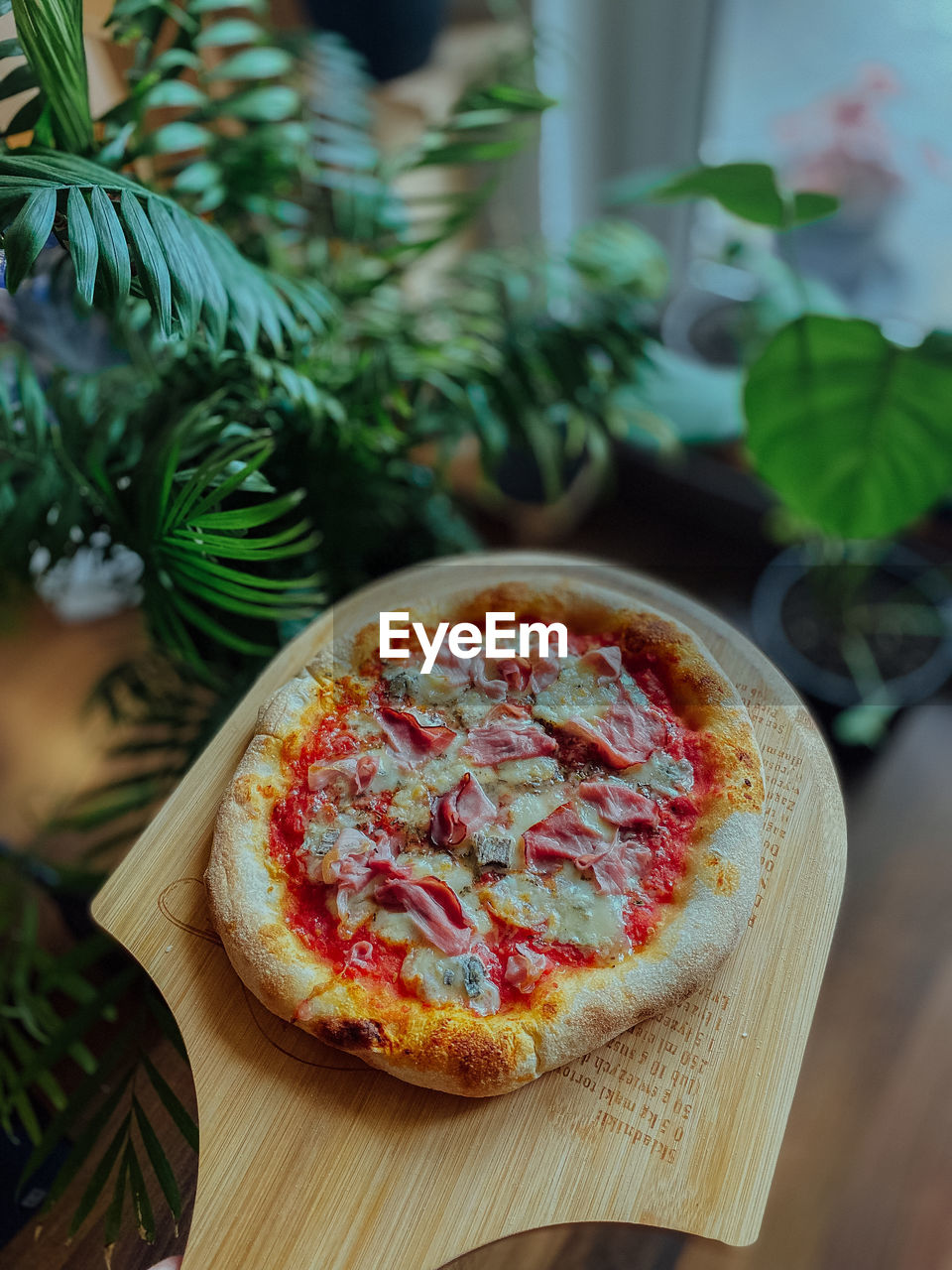 food and drink, food, fast food, pizza, dish, herb, freshness, plant, indoors, baked, fruit, meal, italian food, vegetable, table, produce, cuisine, healthy eating, leaf, no people, plant part, wood, domestic room, dairy, cheese