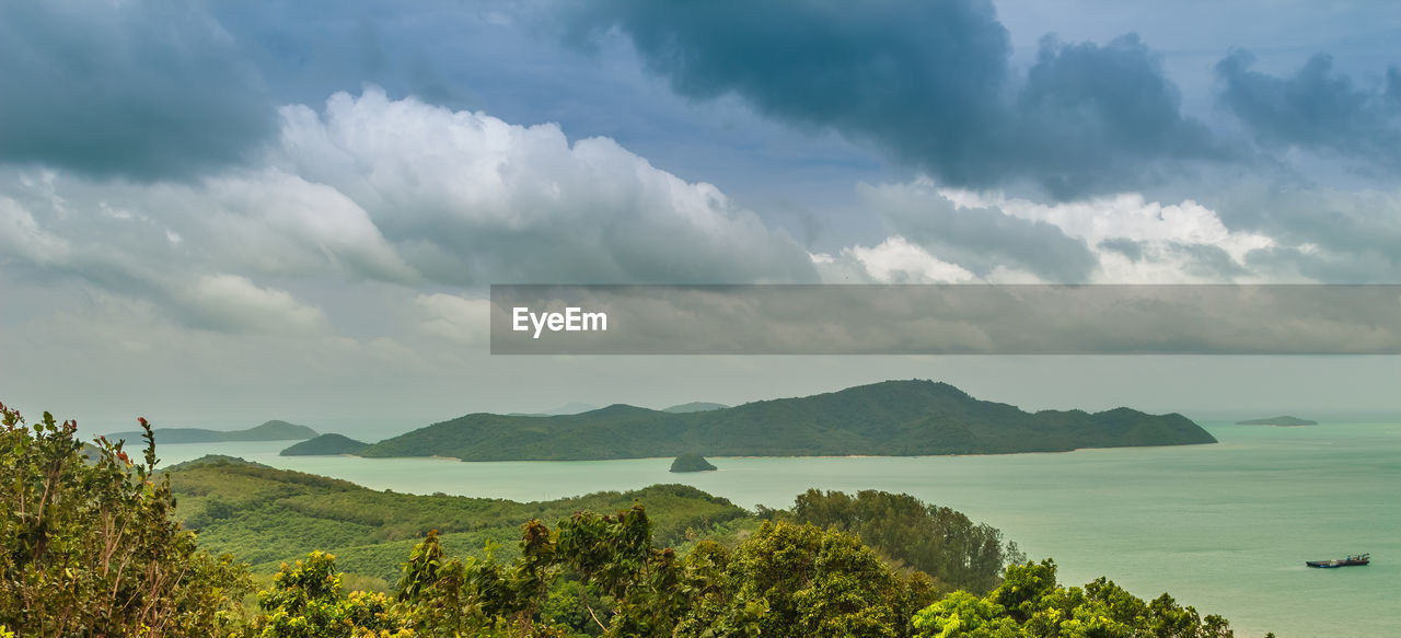 Panoramic view of trees and mountains against sky