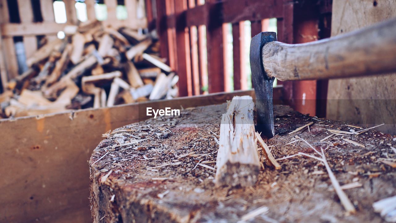 CLOSE-UP OF RUSTY CHAIN ON WOOD OUTDOORS