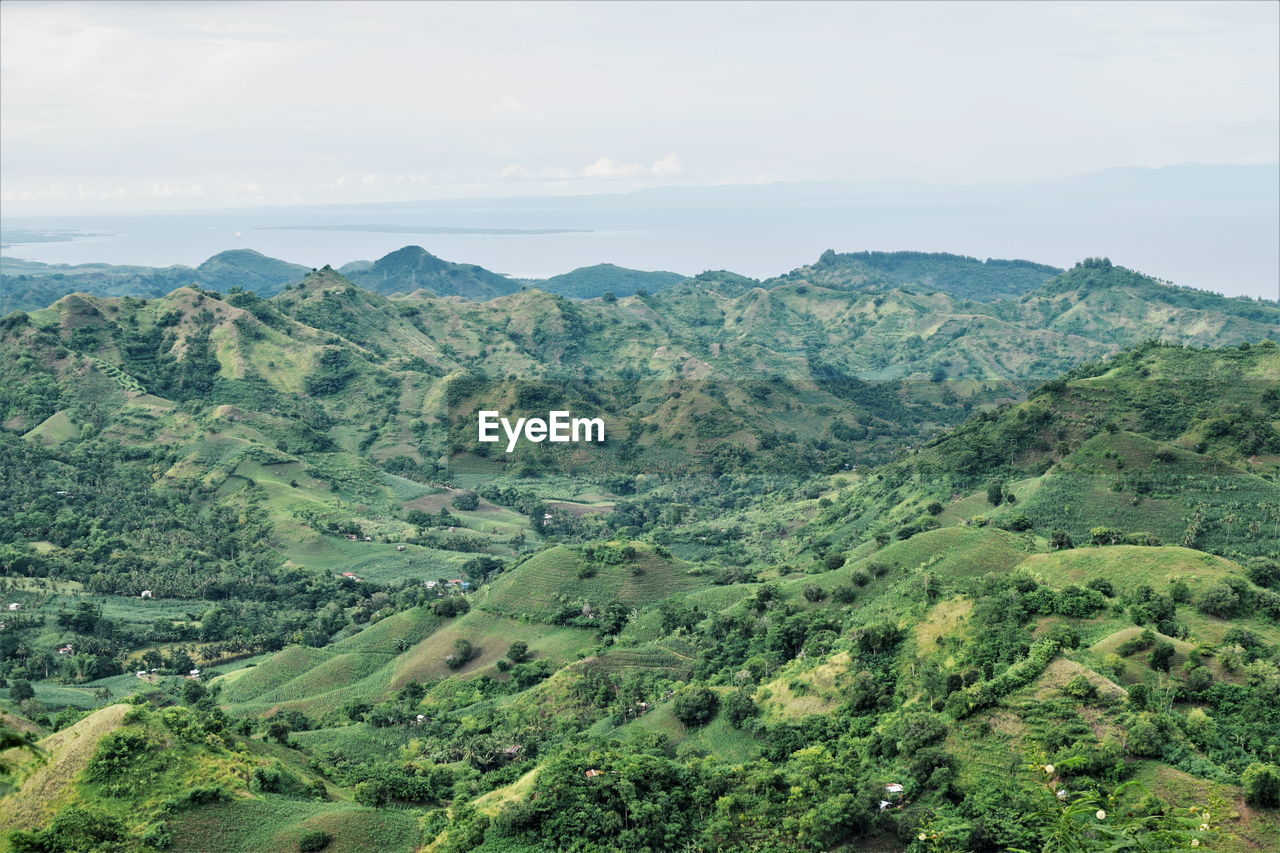 HIGH ANGLE VIEW OF MOUNTAINS AGAINST SKY