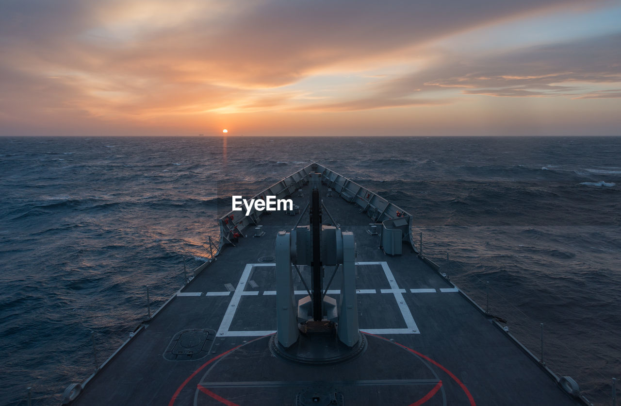 Nautical vessel on sea during sunset