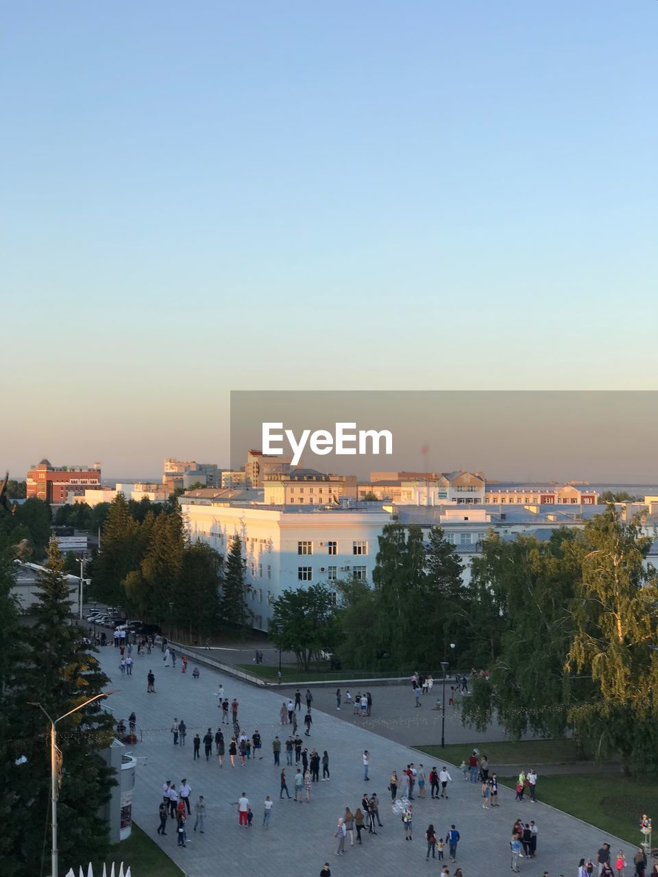 High angle view of people in city against sky during sunset