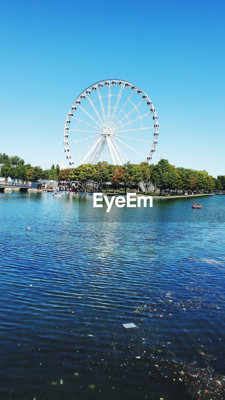 Ferris wheel against clear blue sky