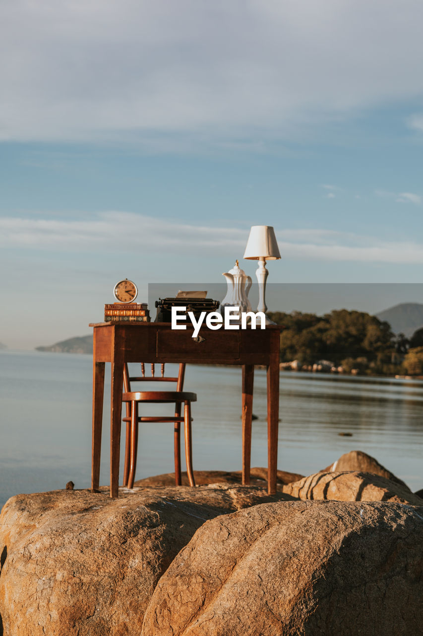 Old desk. work table with a beautiful landscape. desk with books, clock, lamp. nomad life.