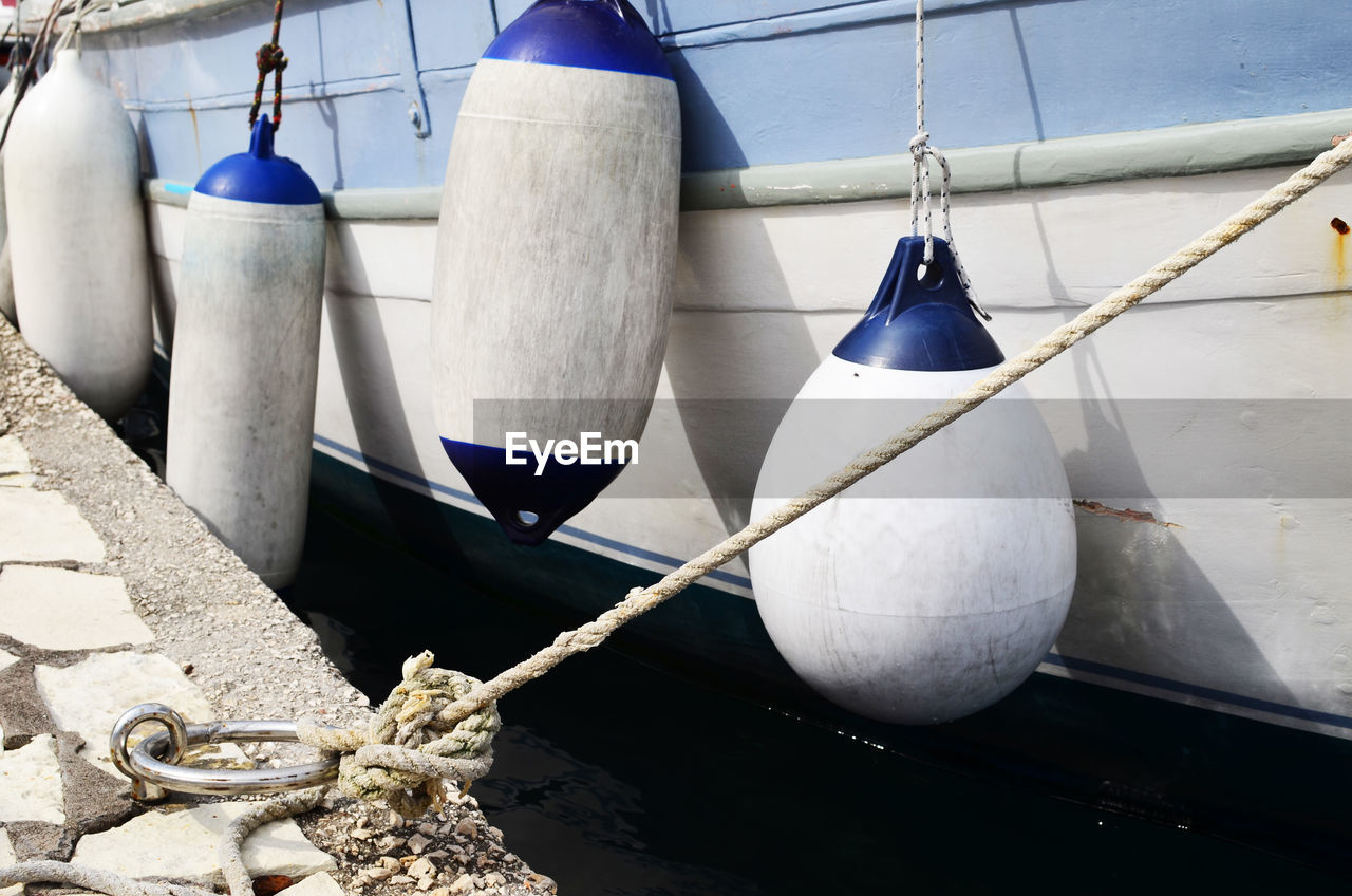 Close-up of buoys hanging on boat