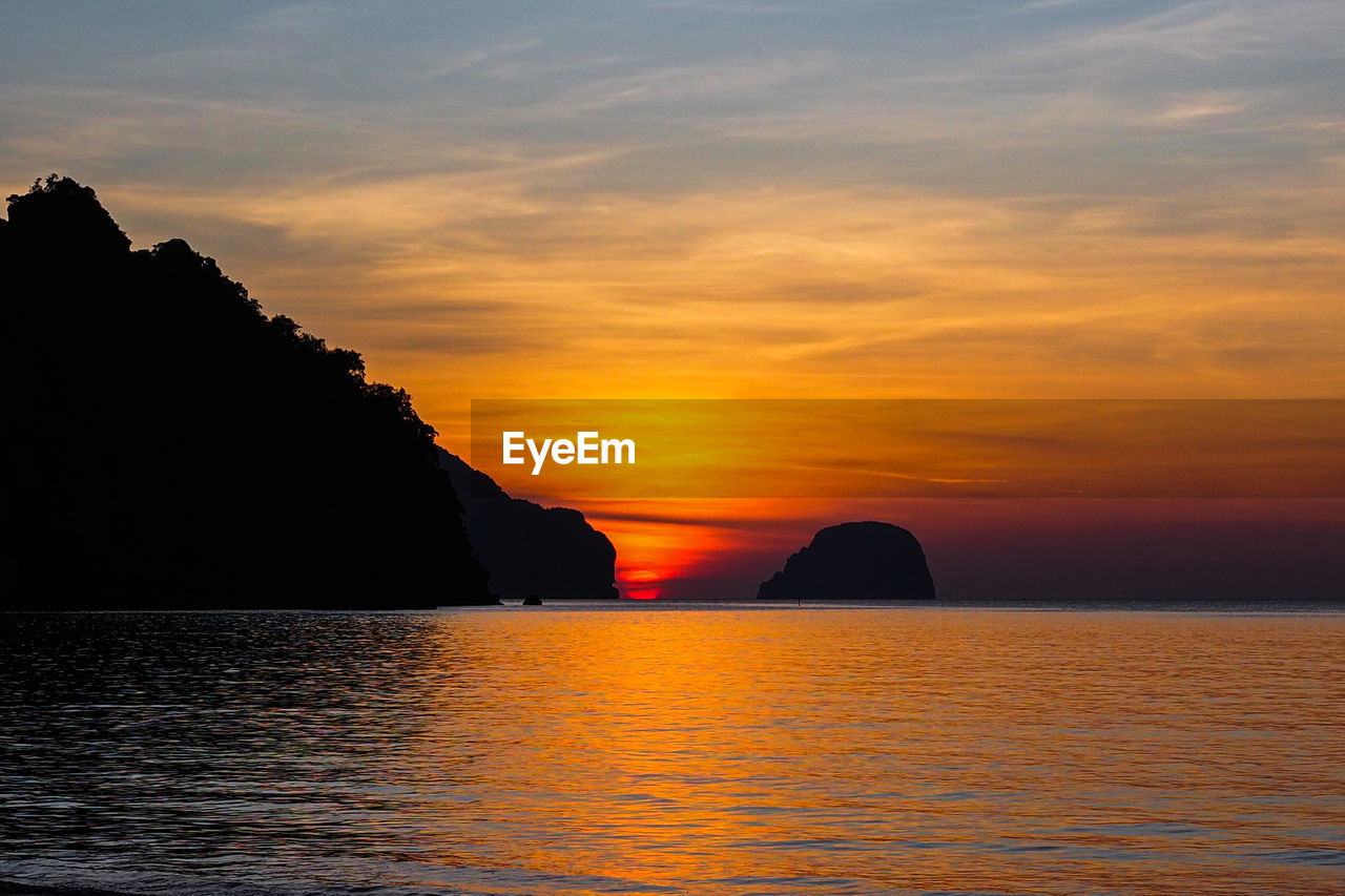 Scenic view of sea against romantic sky at sunset