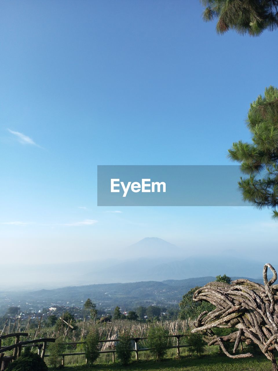 sky, tree, plant, nature, scenics - nature, landscape, beauty in nature, architecture, environment, no people, blue, tranquility, hill, tranquil scene, day, water, sea, land, outdoors, built structure, vacation, travel destinations, building, rural area, horizon, copy space, travel, cloud, building exterior, tropical climate, palm tree, sunlight, idyllic, clear sky, coast, green, growth