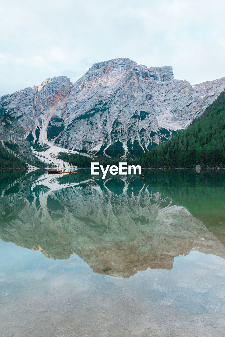 Scenic view of lake by mountains against sky