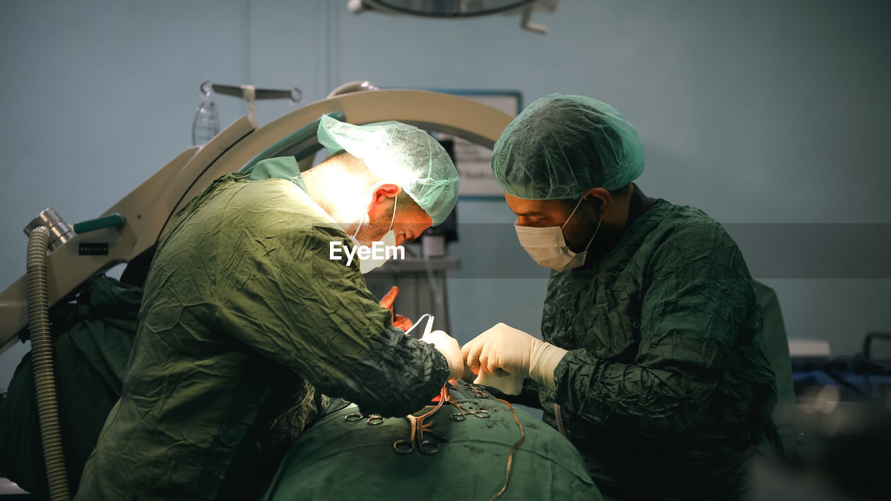 Doctors performing an appendectomy surgery, surgical concept