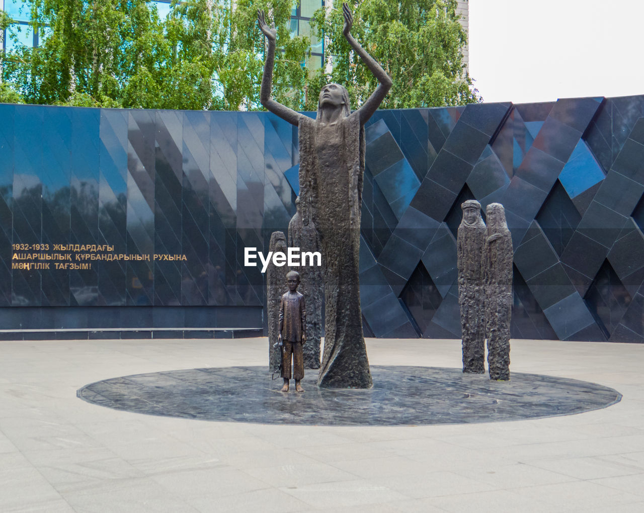 STATUE BY TREES AGAINST PLANTS