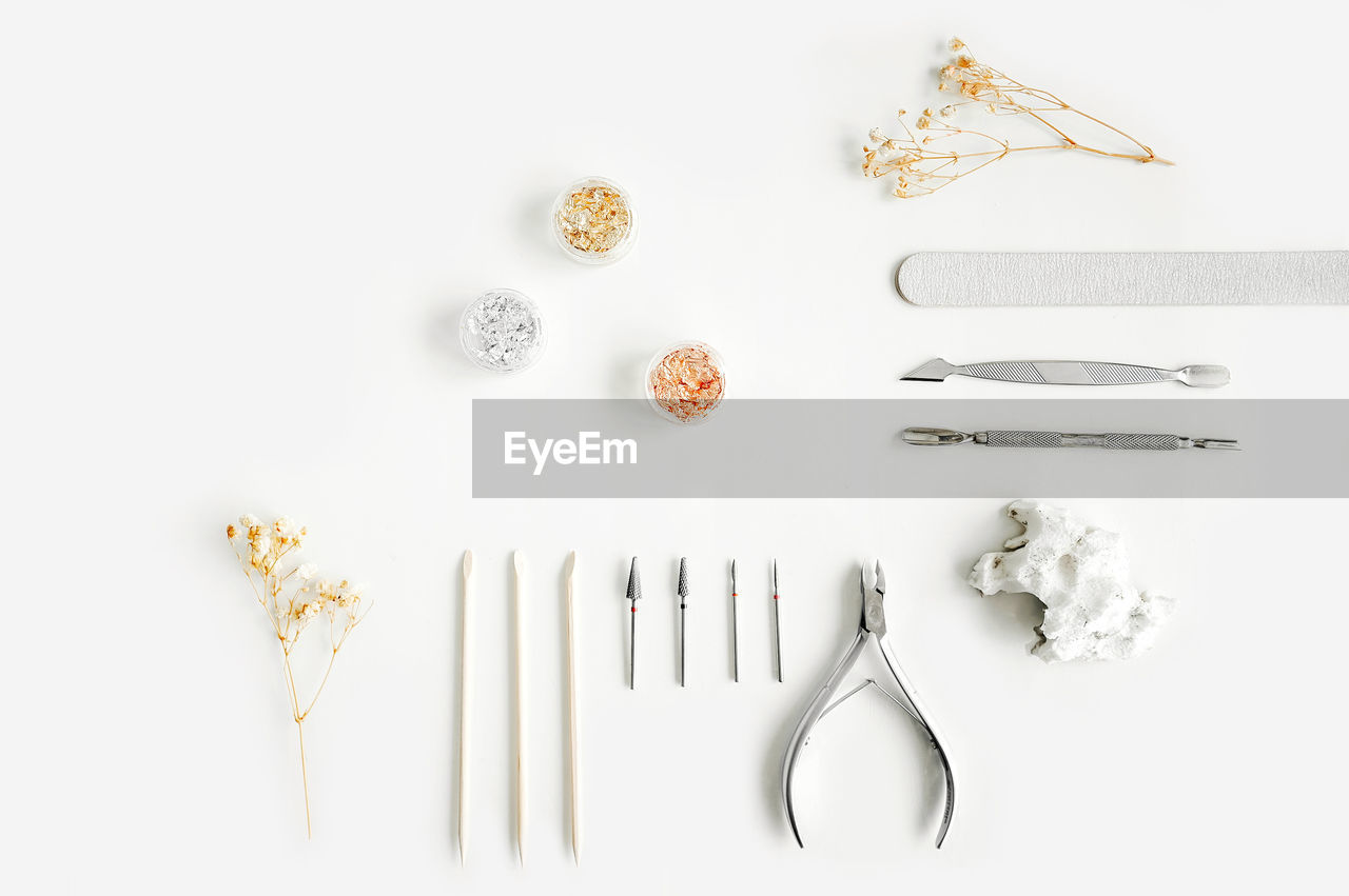 HIGH ANGLE VIEW OF BREAD ON WHITE TABLE AGAINST GRAY BACKGROUND