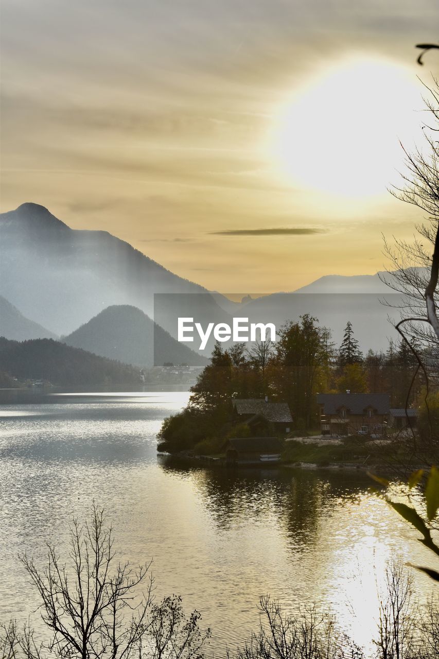 scenic view of lake against orange sky