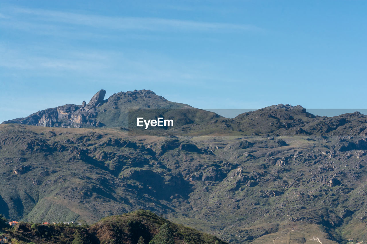 Scenic view of mountains against blue sky