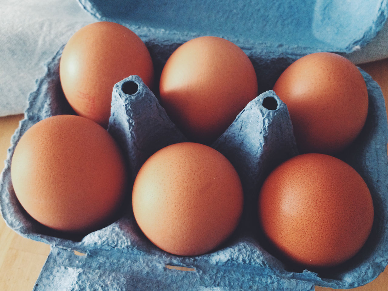 Close-up of brown eggs in crate