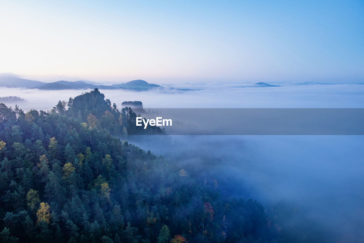 Mountain islands and misty valley, mountain peak with cabin at sunrise. beautiful autumn panorama