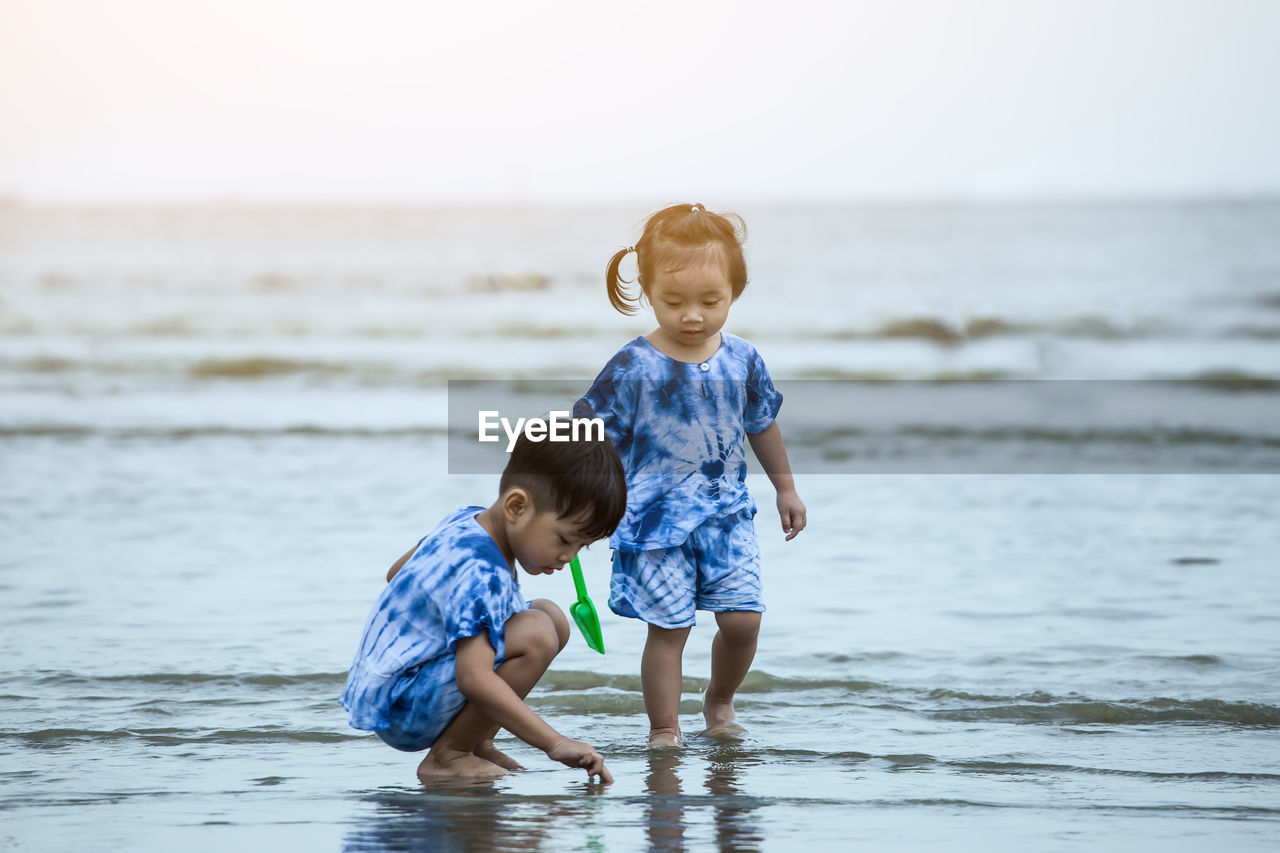 Siblings playing at beach