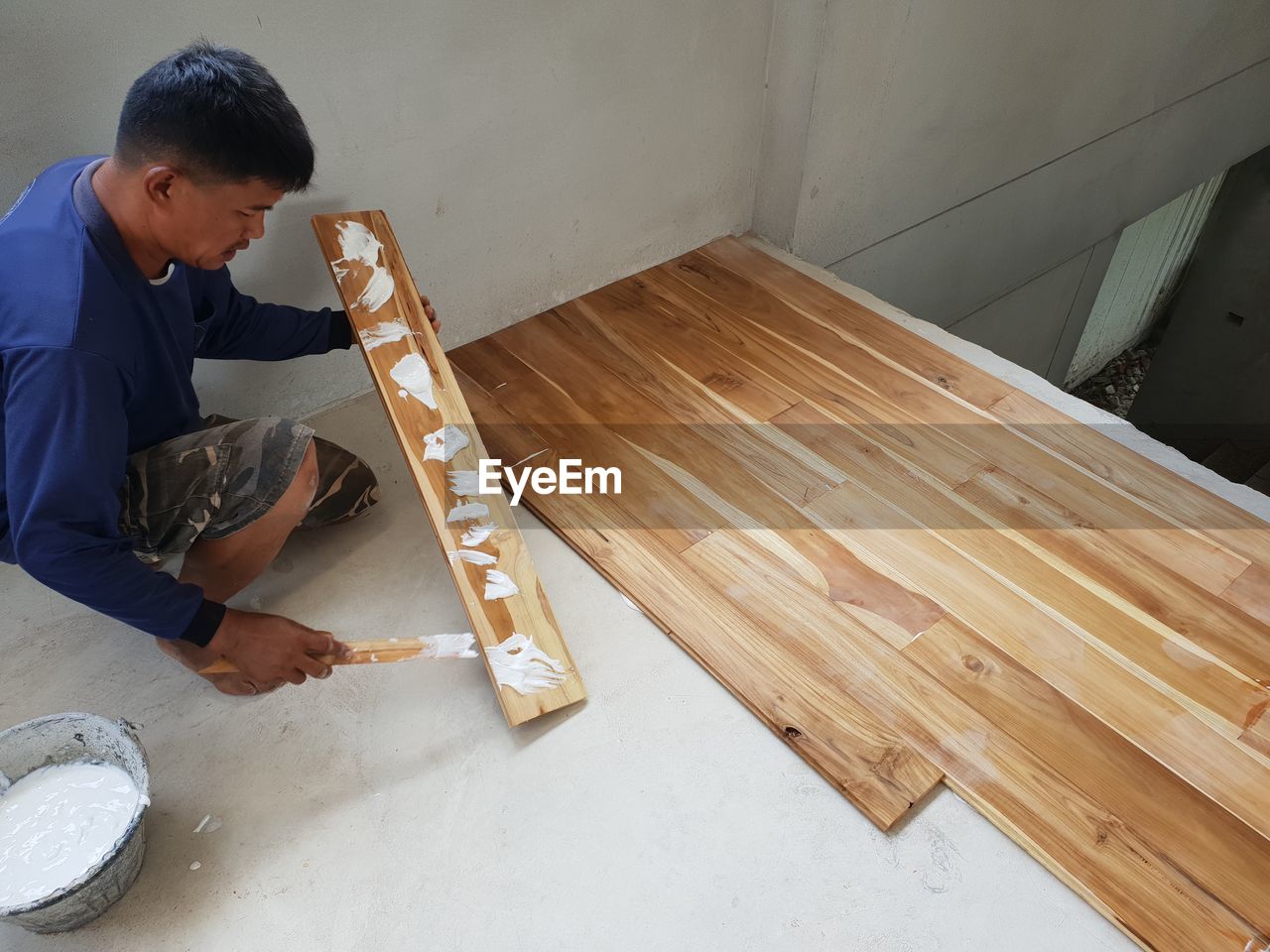 High angle view of carpenter making wooden floor