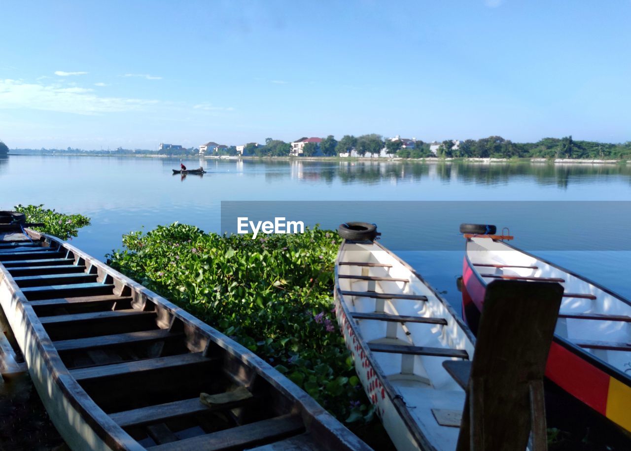 BOATS IN LAKE AGAINST SKY