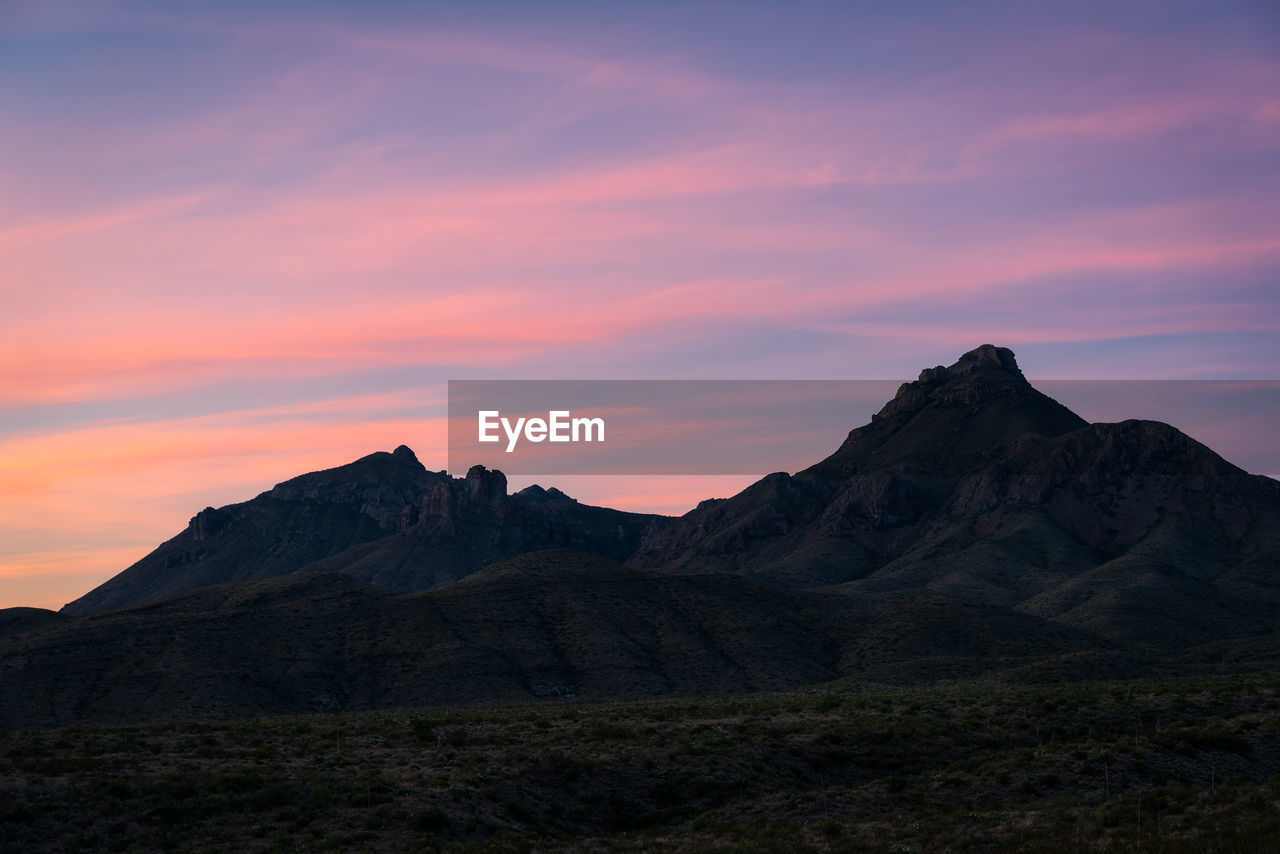 SCENIC VIEW OF MOUNTAIN RANGE AGAINST SKY DURING SUNSET