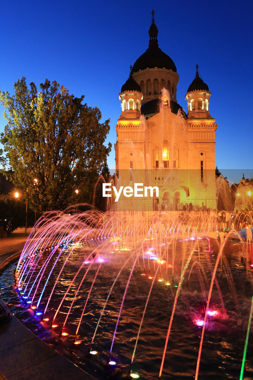 ILLUMINATED FOUNTAIN AT NIGHT