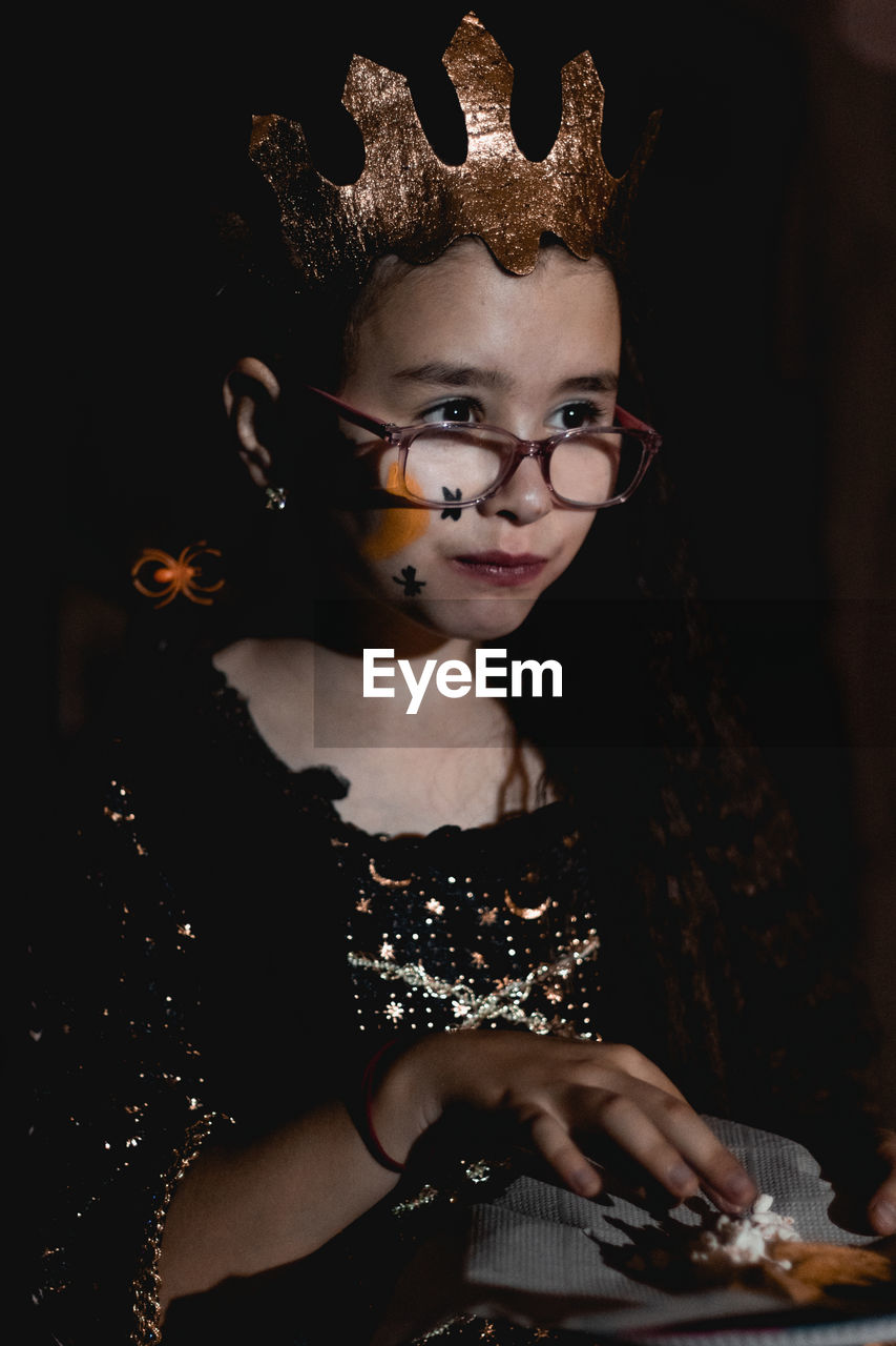 Portrait of a girl in a halloween costume with popcorn.