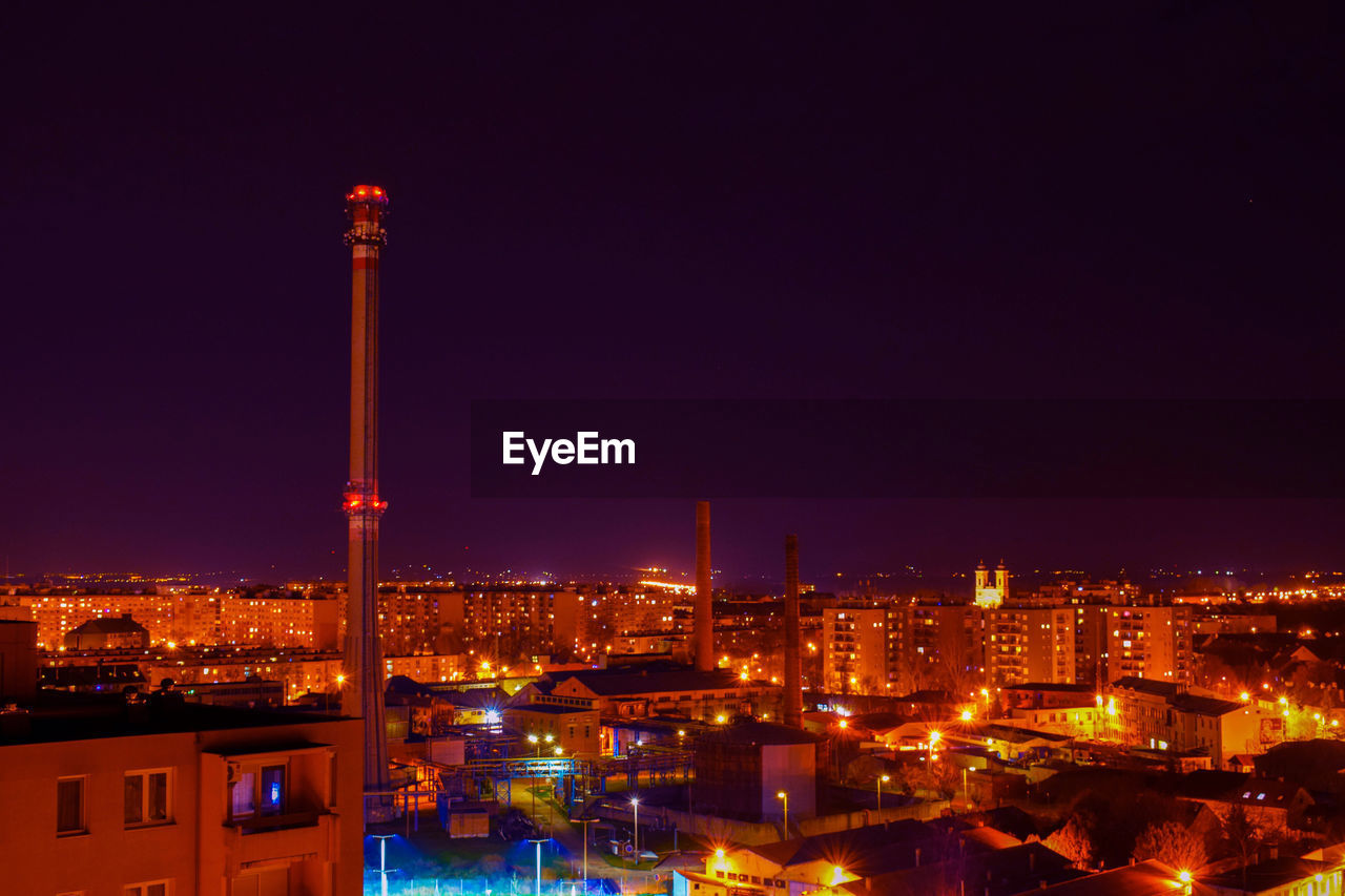 HIGH ANGLE VIEW OF ILLUMINATED CITY BUILDINGS AGAINST SKY
