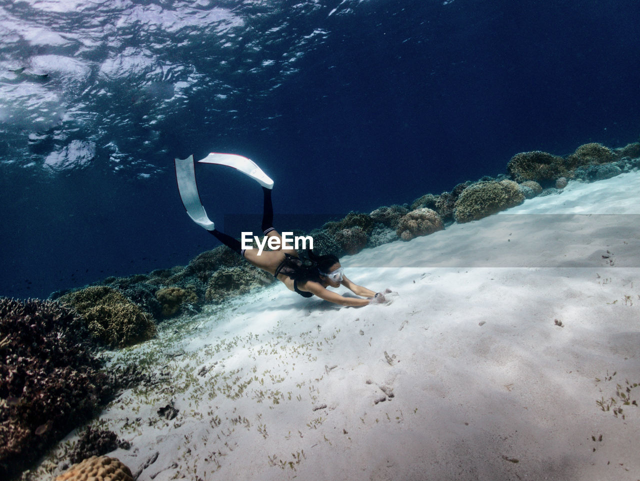 Freediver girl in the sand