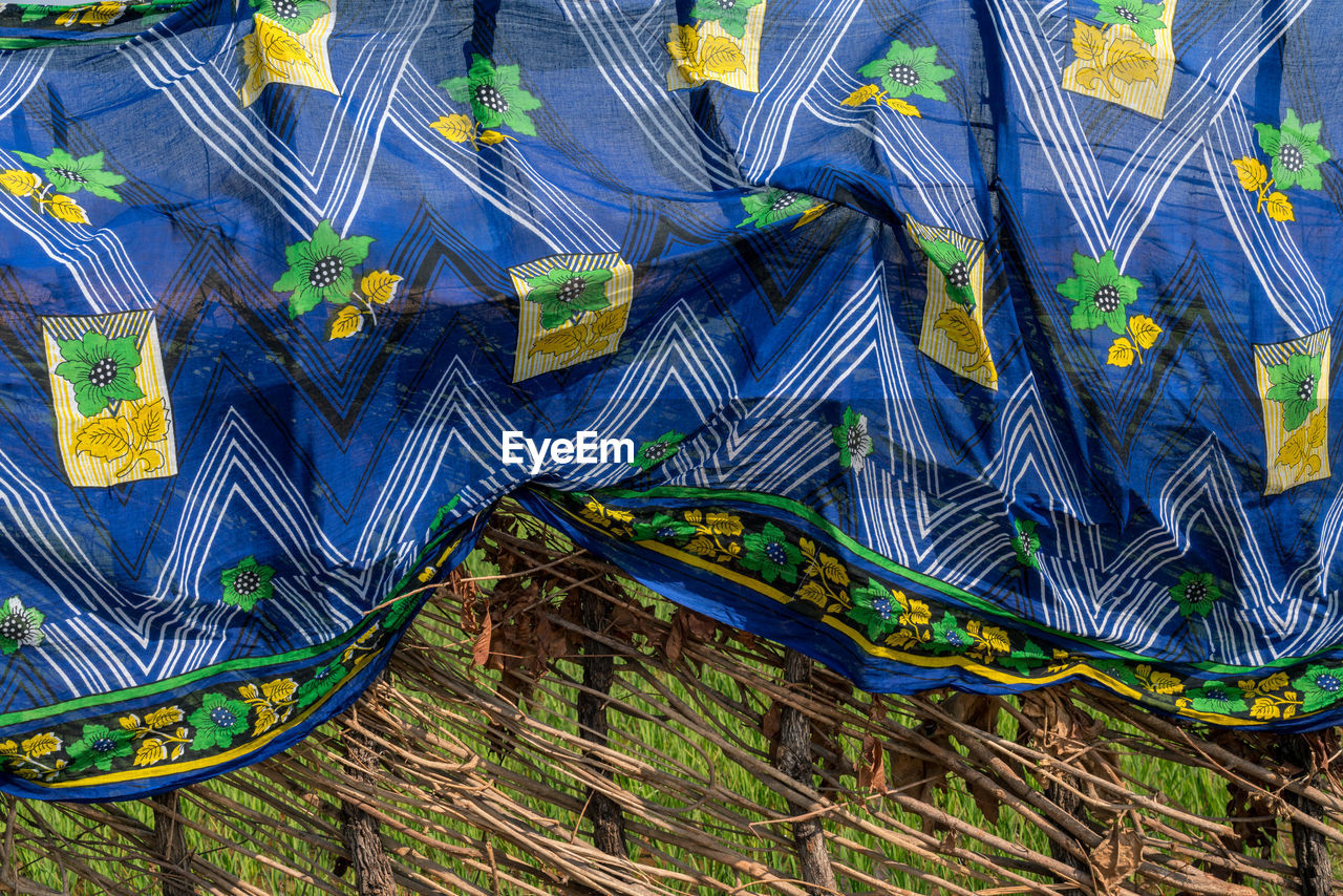 Full frame shot of sari drying on fence