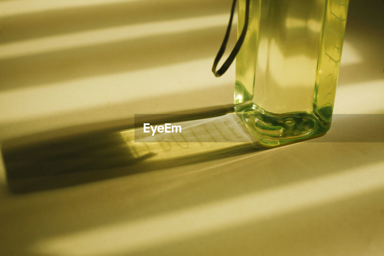 Close-up of yellow bottle on table