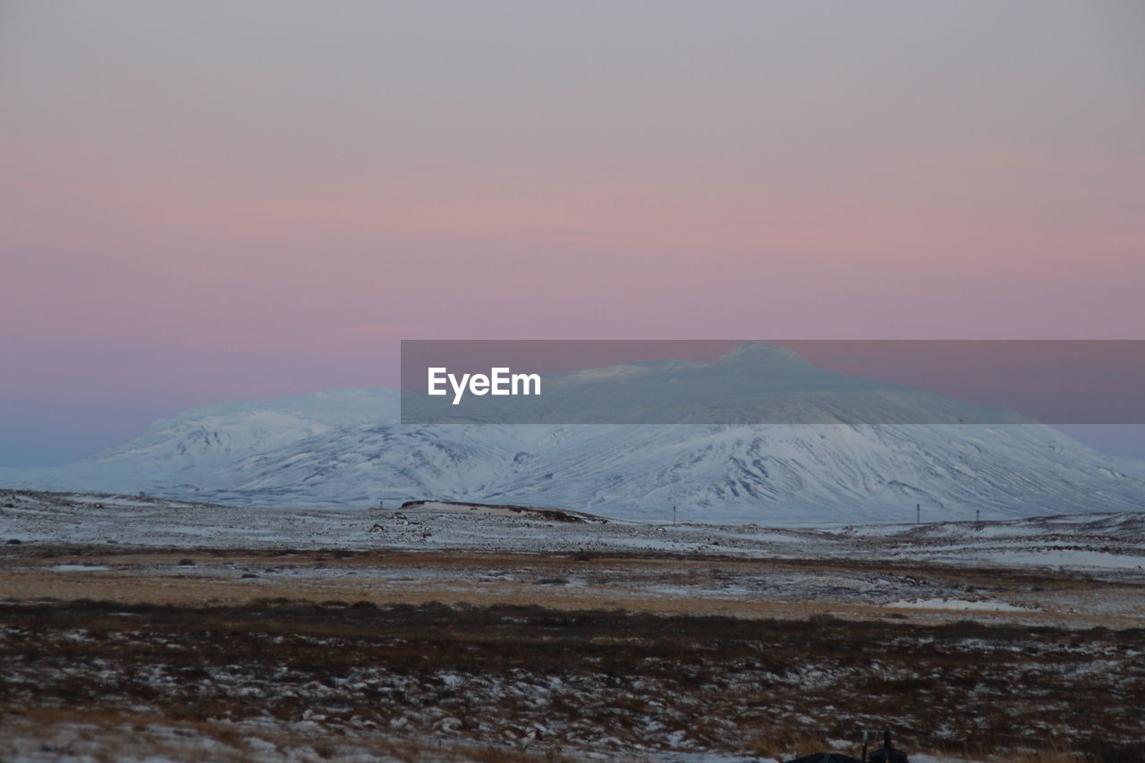 SNOWCAPPED MOUNTAINS AGAINST SKY DURING SUNSET