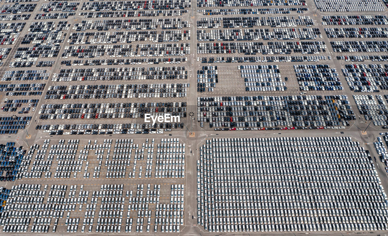 Aerial view of new cars lined up at industrial port to export