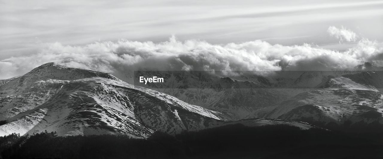 Scenic view of tarcu mountains against cloudy sky