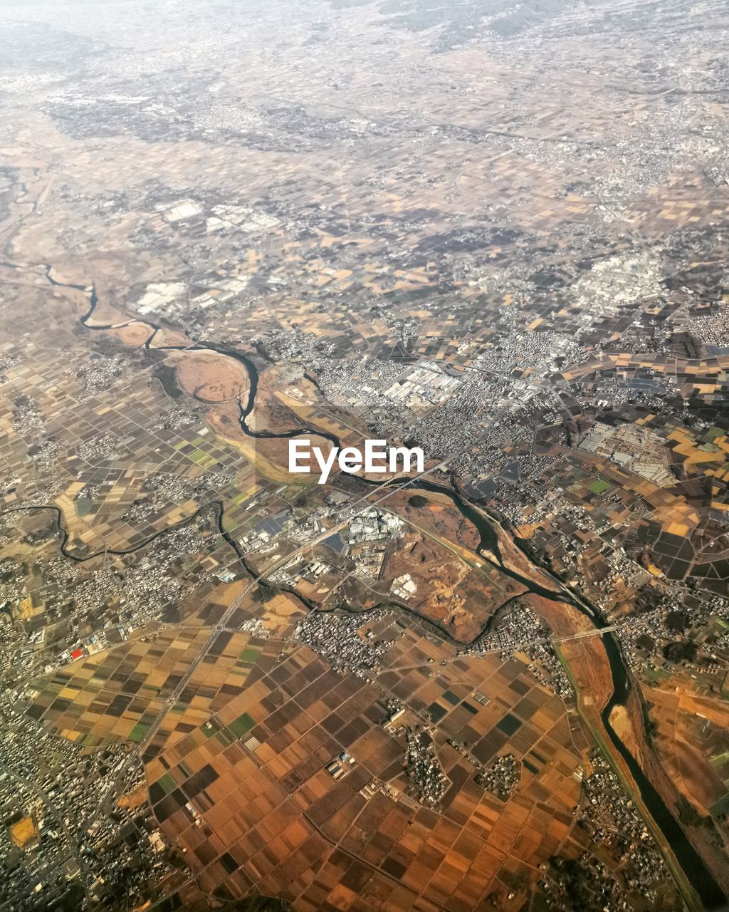 HIGH ANGLE VIEW OF CITYSCAPE FROM AIRPLANE