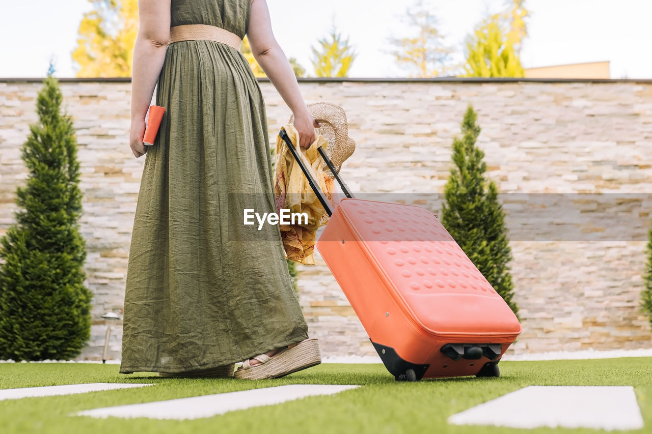 rear view of woman standing on grass