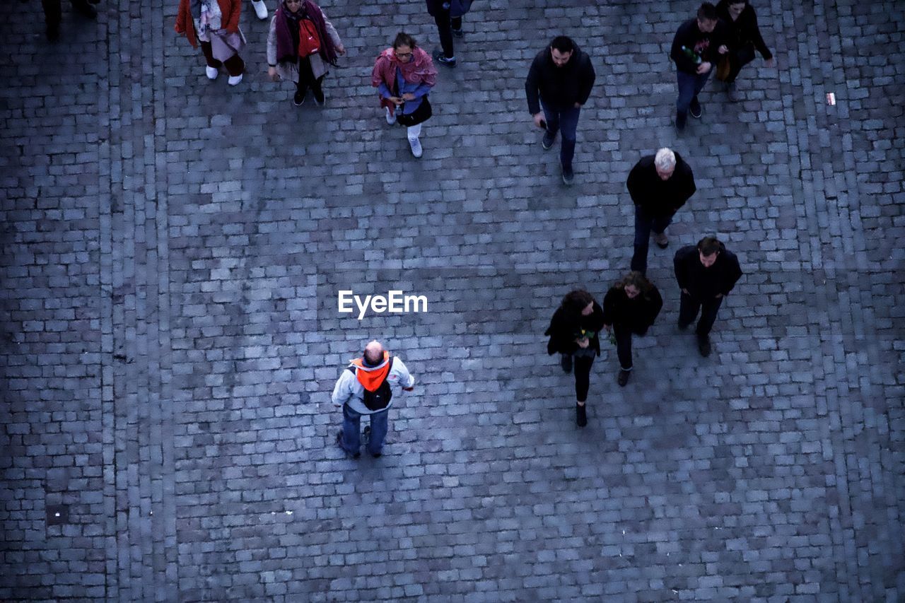 HIGH ANGLE VIEW OF PEOPLE WALKING ON STREET