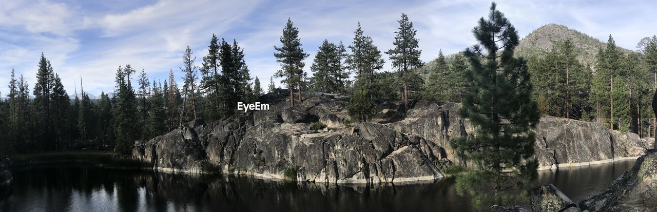 Panoramic view of lake in forest against sky