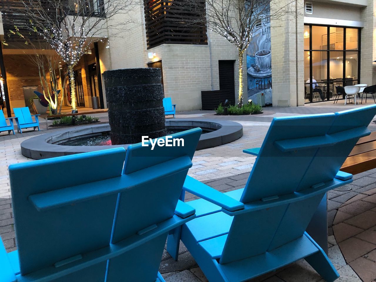 EMPTY CHAIRS AND TABLE BY BUILDINGS