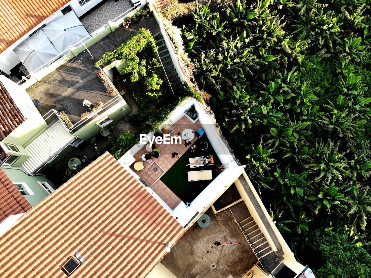 HIGH ANGLE VIEW OF SWIMMING POOL AMIDST BUILDINGS