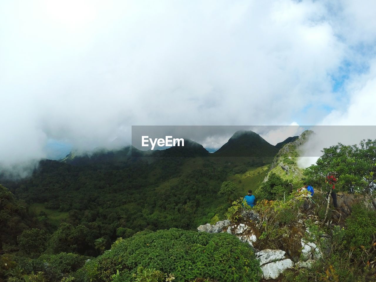 Scenic view of mountains against cloudy sky